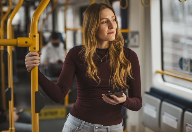 A passenger holding a rail on board a Supertram